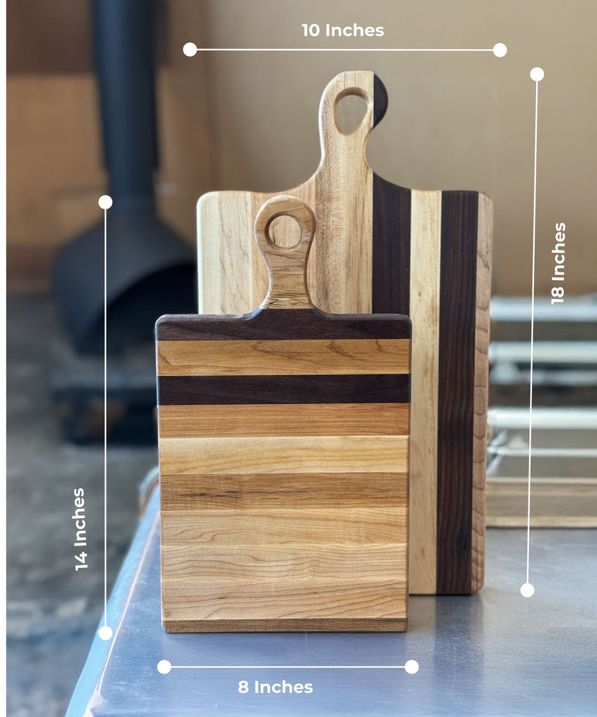 Two handcrafted wooden cutting / charcuterie boards made of maple and walnut. The smaller board measures 8x14inch & the larger one measures 10x18inch. Both boards showcase a sleek design with a natural wood finish, perfect for kitchen & serving use.