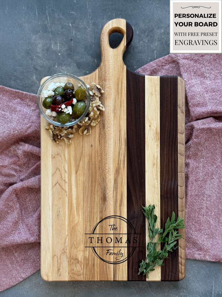 Custom engraving on a maple & walnut  solid wood charcuterie / cutting board on a red cloth