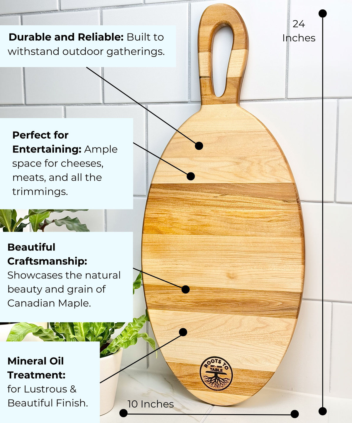  An oval-shaped 24-inch Canadian maple charcuterie board with a handle, featuring a Roots to Table logo. Highlighted features include beautiful craftsmanship, mineral oil treatment for a glossy finish, and ample space for entertaining. Displayed against a tiled wall with a green plant nearby.