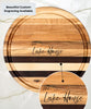 Round wooden cutting board with alternating maple and walnut stripes, featuring a juice groove and engraved text The Lake House. A close-up highlights the elegant engraving detail, perfect for personalized home or gift use.