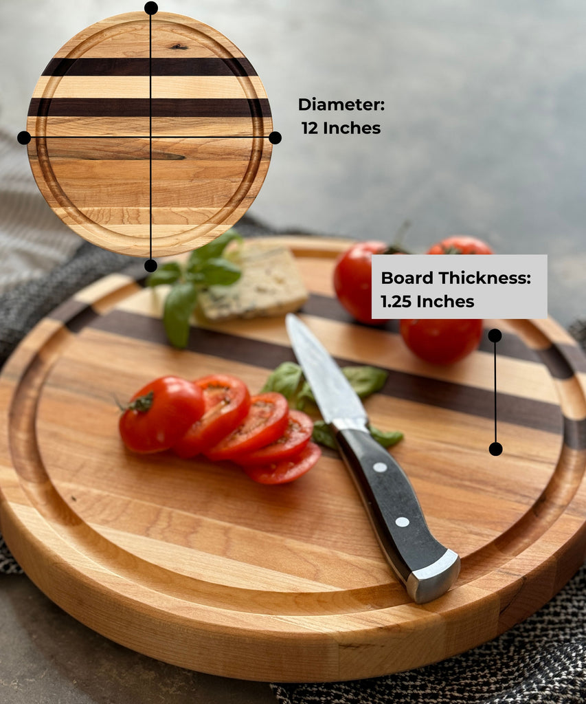 Round wooden edge grain cutting board with maple & walnut stripes, personalized engraving, & a juice groove. Pictured from a side view to appreciate the board thickness of 1.25 inches & 12 inch diameter. A stylish & functional serving or prep piece.