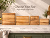 Four rectangular wooden cutting boards in different sizes arranged on a marble countertop, with text reading Choose Your Size Sugar Maple Edge Grain and size labels below each board.