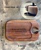 A rectangular dark walnut wine and cheese tray measuring 9 inches by 5.5 inches and 1 inch thick, featuring a wine glass holder and engraved text reading if you can read this, you need more cheese.