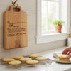 freshly baked cookies cool on a rack below a hanging wooden recipe board used as kitchen decor