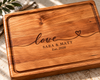 Handcrafted cherry wood cutting board featuring personalized love engraving with names Sara and Matt and an established date. Beautiful warm cherry hardwood with natural grain, rounded corners and a juice groove. A meaningful personalized wedding, anniversary or bridal shower gift designed for everyday use and lasting memories.