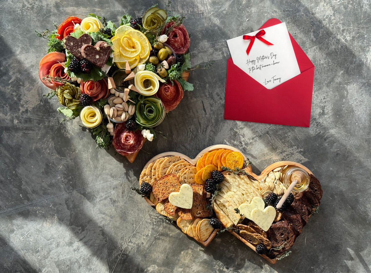 Beautiful edible arrangements on the heart charcuterie board and for the real wood serving tray which features an array of crackers and honey. A mothers day card is also in the photo to showcase just how beautiful mom's gift can be!
