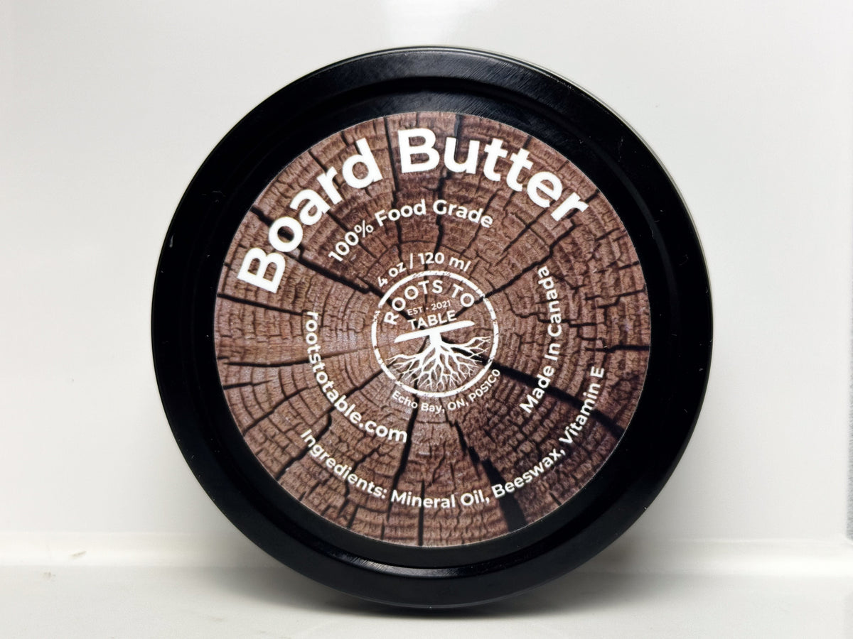 Tin of Roots to Table Board Butter, labeled as 100% food grade with ingredients including mineral oil, beeswax, and vitamin E. 