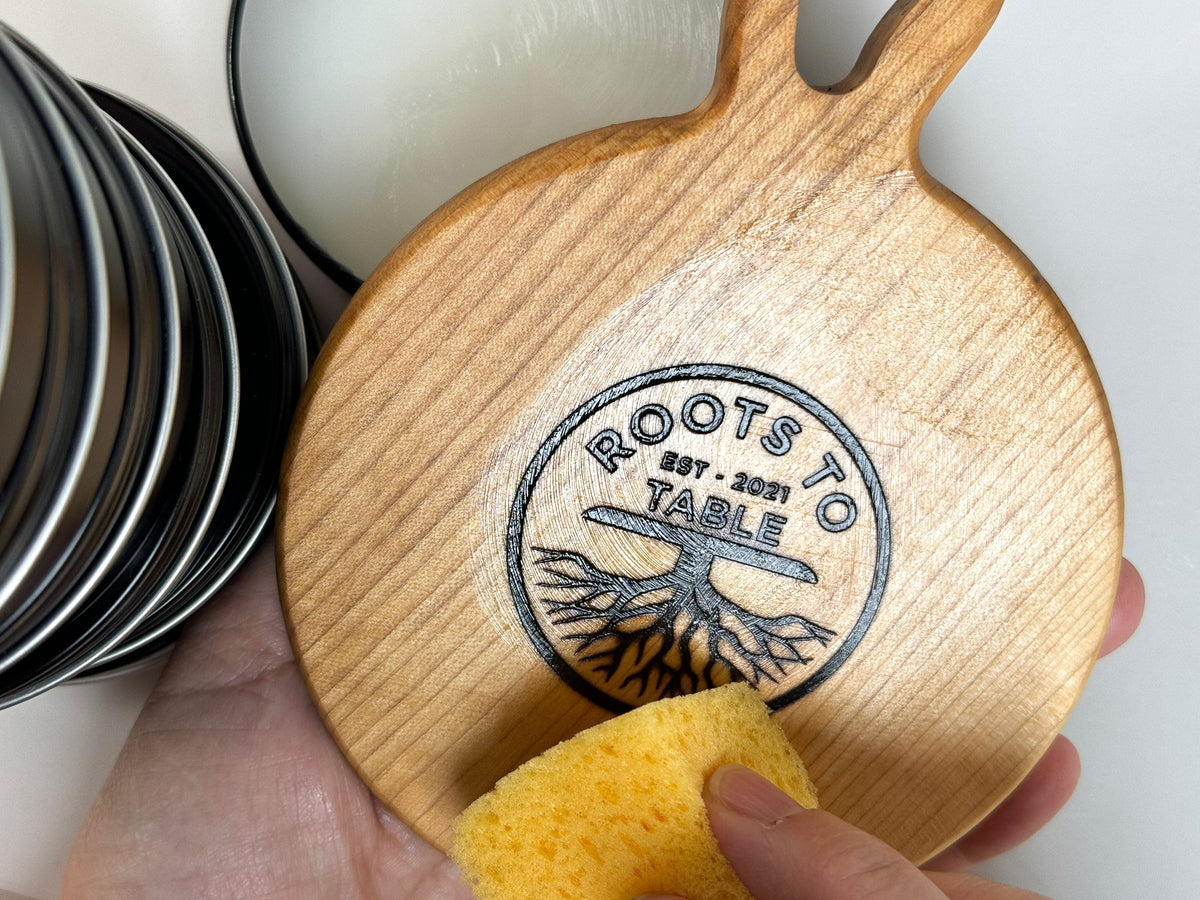 Applying board butter to a maple board with a yellow sponge
