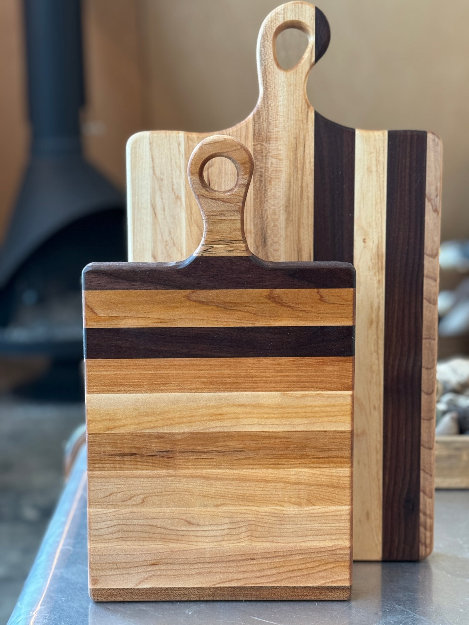 Large personalized wooden charcuterie / cutting board with Rachel Kitchen and below that, Bon Appétit engraved. Featuring elegant walnut and maple stripes, garnished with salami roses, cheese, berries, and crackers. Perfect for hosting and gifting.