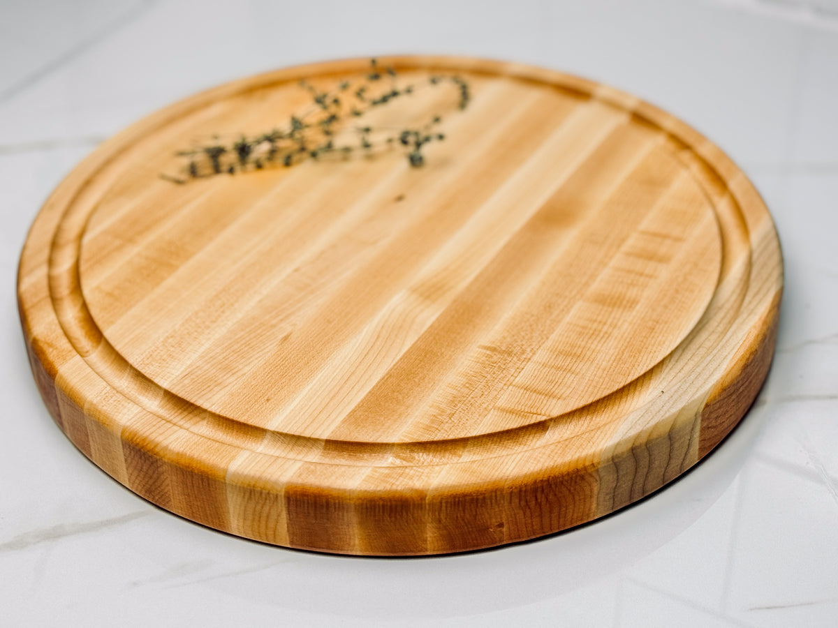 A one inch thick round maple edge grain cutting board. Twelve inch diameter.