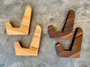 Two sets of cutting board stands. One set is maple and one set is walnut
