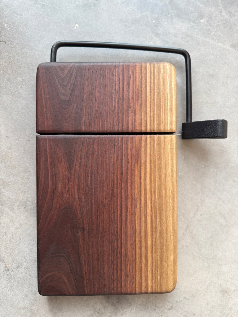 A beautiful grain pattern featured on this wooden walnut wire cheese slicer with custom engraving Cheese, Wine & Good Times. The Harris Family