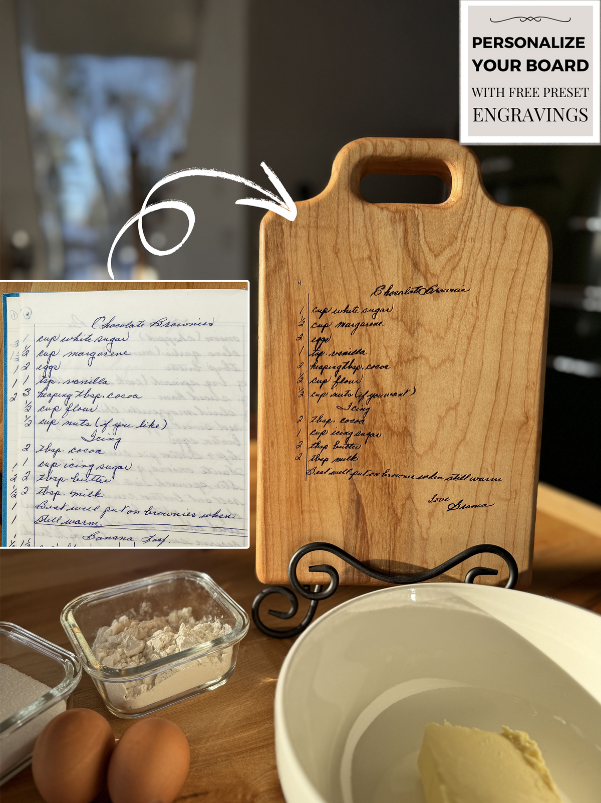 A handwritten brownie recipe is engraved onto a maple cutting board, displayed on a stand. The original recipe note is shown in the corner with a personalize your board badge with free preset engravings
