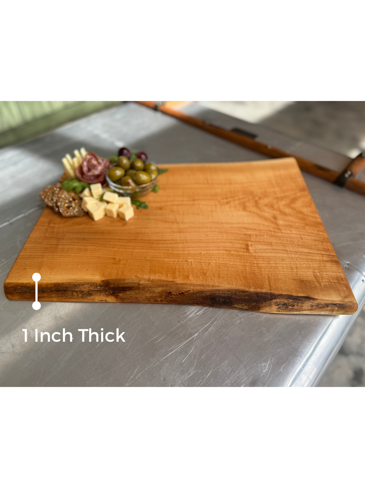 Live edge maple wood charcuterie showcasing the board thickness of 1 inch.
