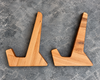 Two matching wooden book stands with a natural maple finish, displayed side-by-side on a textured gray stone surface.