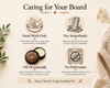 An informational care graphic for a wooden board or tray, titled 'Caring for Your Board,' with four illustrated care instructions and text: hand wash only, dry immediately, oil occasionally, and no dishwasher. The design uses a warm cream background with brown text and icons, plus decorative leaves, dried flowers, and a folded beige textile along the edges.