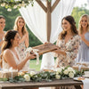 Bride receiving a personalized live edge walnut wooden cutting board at a bridal shower with friends.