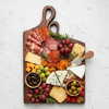 Personalized nesting cheese board styled with charcuterie spread for wedding and anniversary gifting