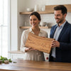 Couple holding a custom engraved cherry live edge charcuterie board wedding gift