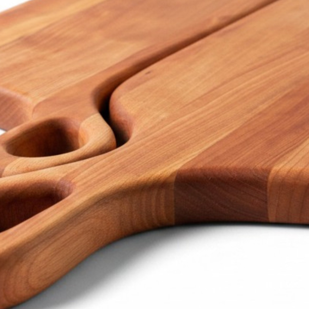 Close up of cherry wood grain pattern and handle details of nesting cutting boards