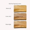 Three wooden cheese boards with engraved text 'Emma & Liam' showing different locations for personalization.