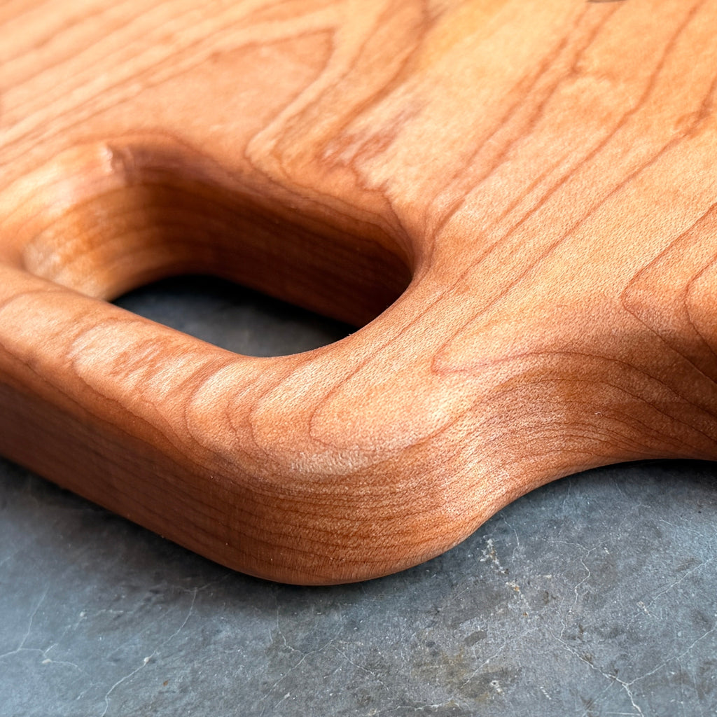 Close up of handle and grain detail of maple cutting board.