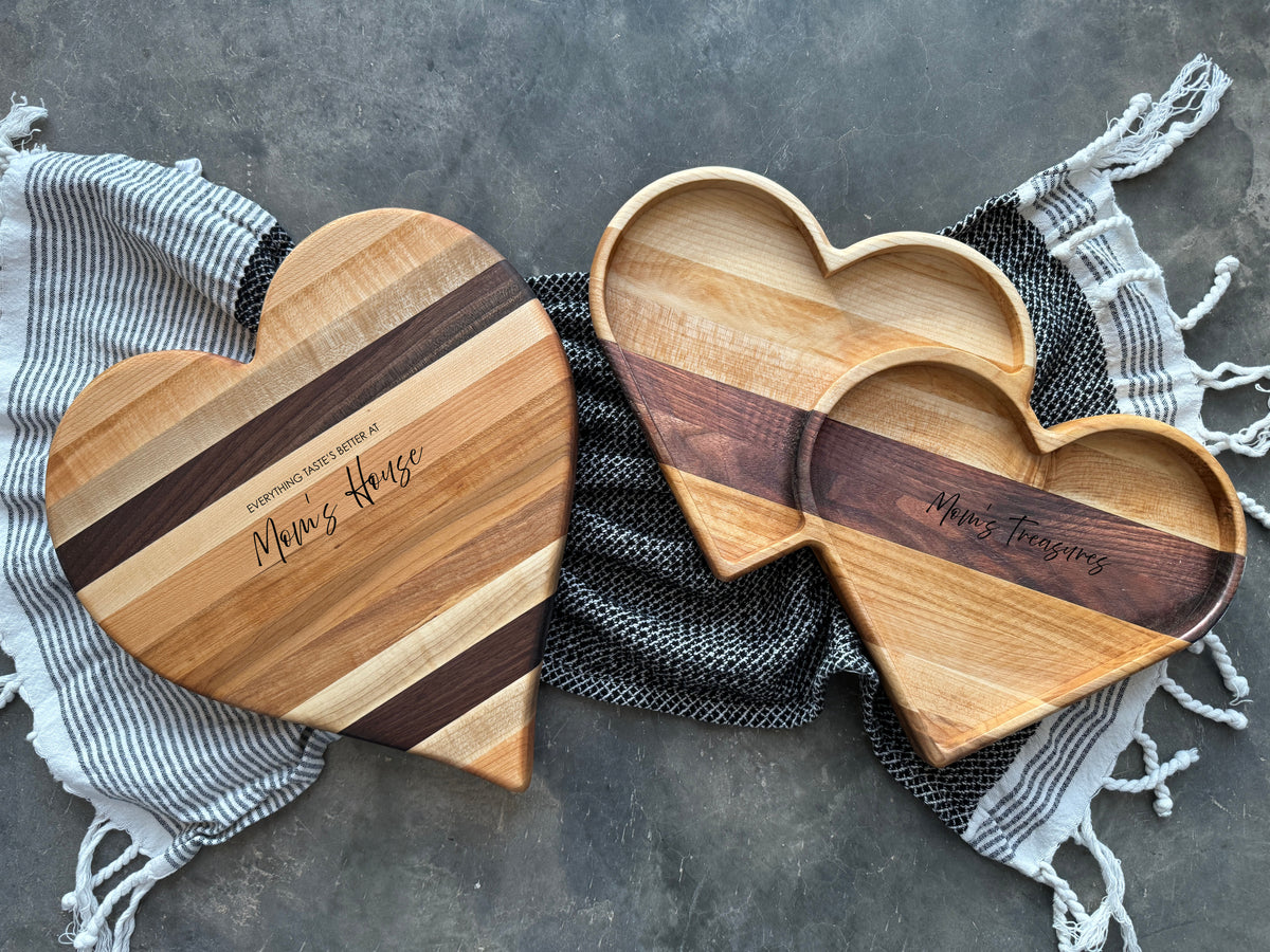 Heart shaped cutting board and reversible charcuterie board, with matching maple and black walnut double heart tray catch all.