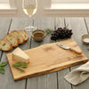 live edge maple wooden cutting board with cheese, bread, and a personalized engraving of a family name.