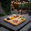 Personalized nesting charcuterie board displayed outdoors for romantic entertaining and wedding gift inspiration