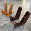 Two standing sets of cutting board stands. One set is maple and one set is walnut