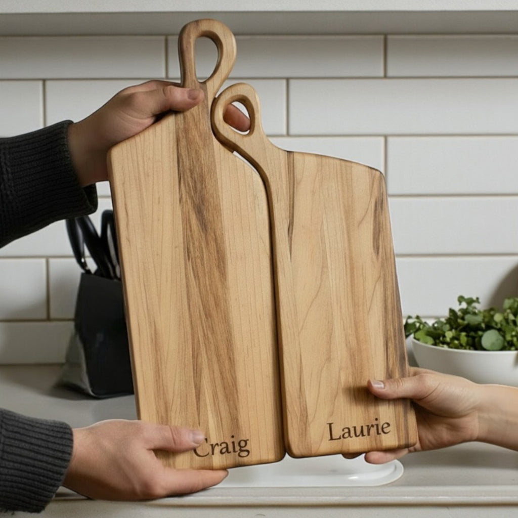 Personalized nesting charcuterie board set is being gifted in a kitchen setting with engraved couple names.