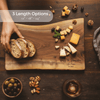 personalized walnut charcuterie board with bread, cheese, and nuts on a wooden surface, featuring 'Hans & Venerika' engraving