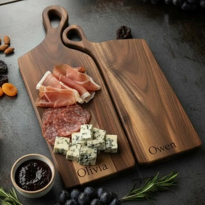 Personalized nesting charcuterie board set in walnut, maple and cherry wood with engraved names, styled with cheese and cured meats for wedding and anniversary gifting