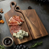 Personalized nesting charcuterie board set in walnut, maple and cherry wood with engraved names, styled with cheese and cured meats for wedding and anniversary gifting