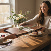 Two people exchanging a gift of walnut wooden cutting board as a housewarming gift 